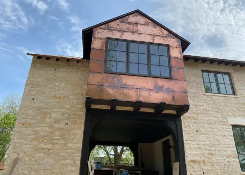 Copper metal panel facade on a stone building for Skylight Installation in Hinsdale