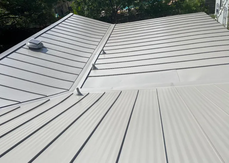Solar attic fan installed on a metal roof for Roof Ventilation in Hinsdale